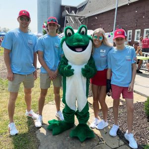Group of people with the Bags of Fun Frog Mascot