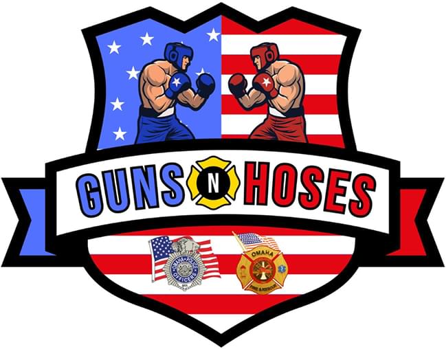 Guns N Hoses logo. Shows a officer badge with an american flag in it. On the left is a blue boxer and on the right a blue boxer. The words are on the logo as well as a couple images of medals. This is a simplified illustration style logo.