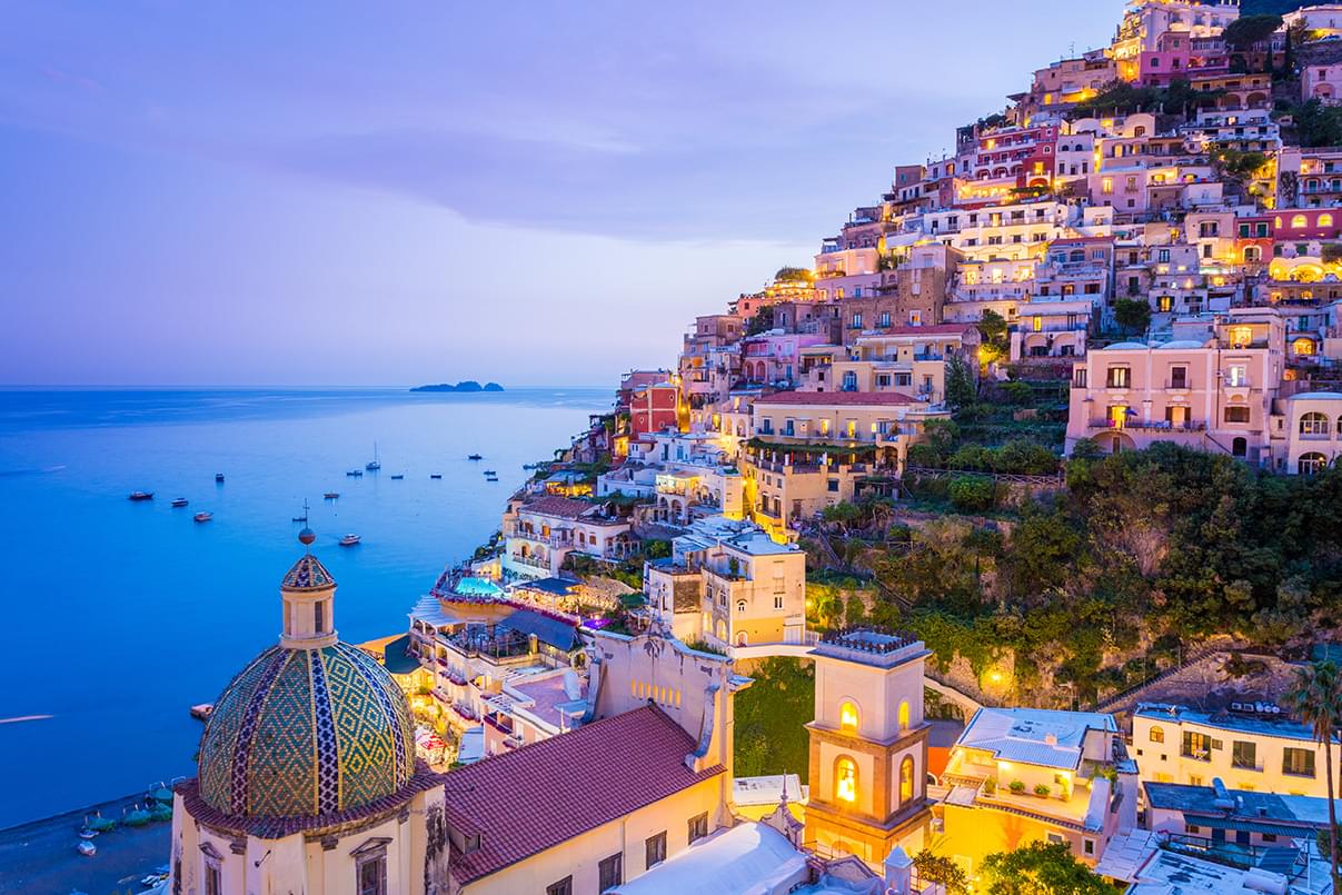 Lots of colorful building along the Amalfi coast with the water behind.