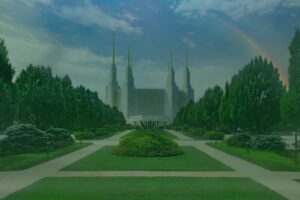 Front view of a make believe castle with a long grass and pavement area in the front, green trees on either side, and a rainbow over the right side.