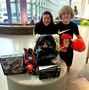 Woman and teen with a bag and all the toys in the hospital lobby.